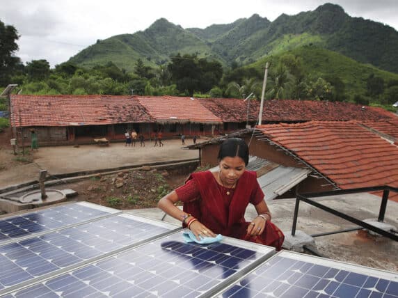 Meenakshi Dewan installing solar panels on a house