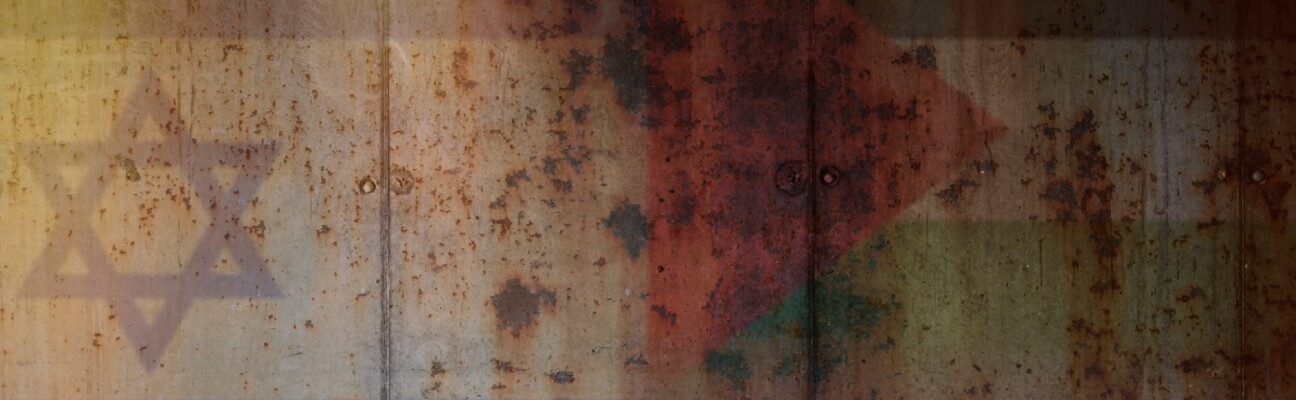 Two flags against a concrete wall